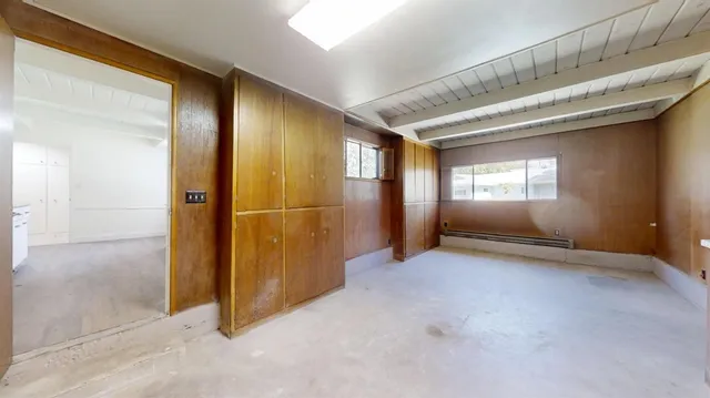 a view of a hallway with wooden shelves