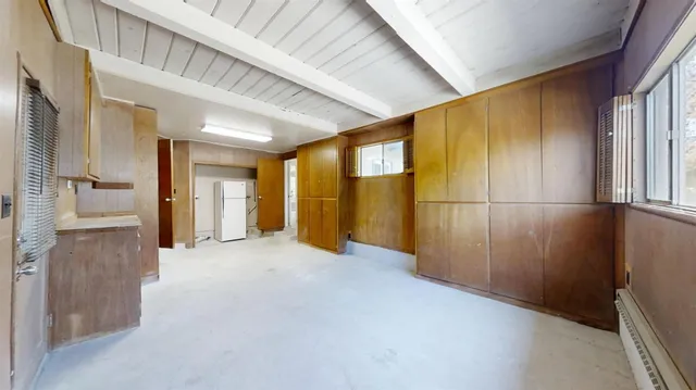 a view of a hallway with wooden shelves