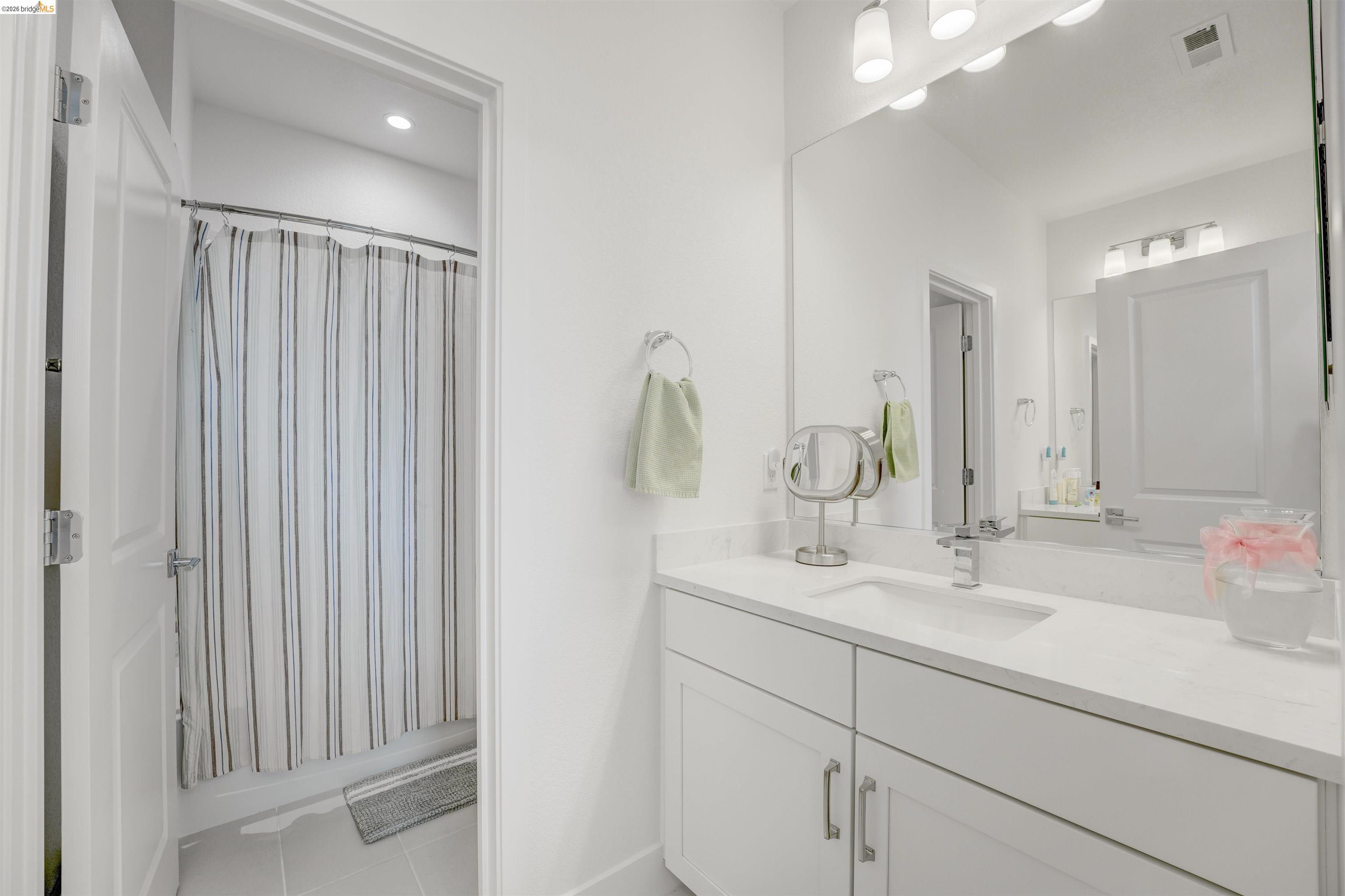 7101 Melon Court San Ramon, CA 94583 - Photo 40 of 58 a bathroom with a double vanity sink and a mirror