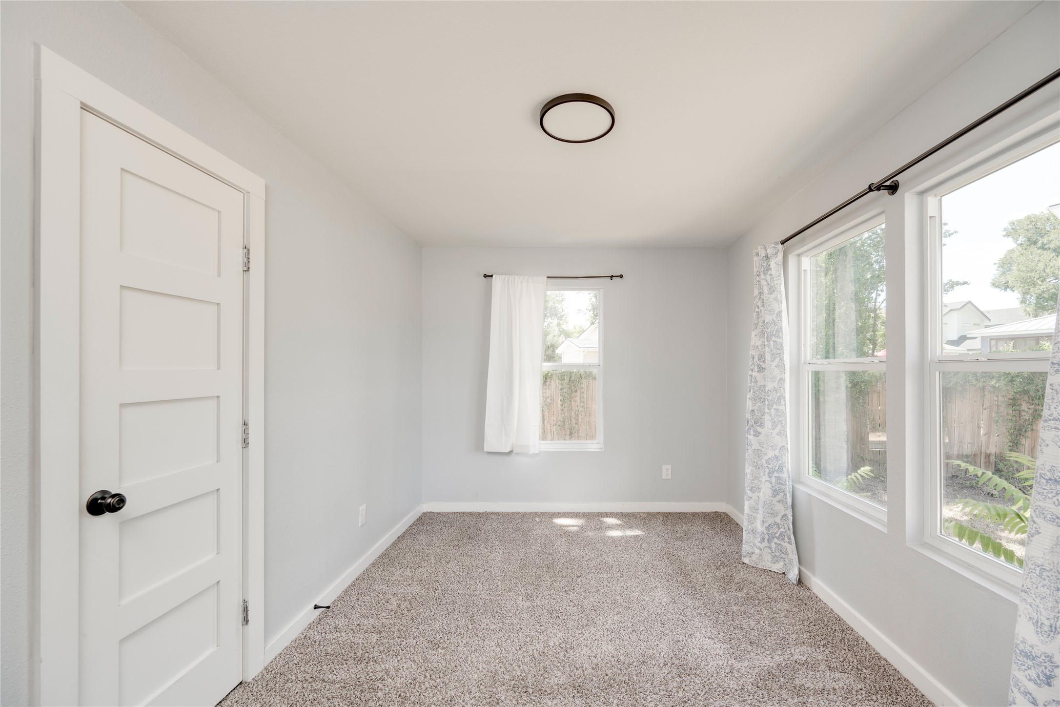 1400 Marcus Place, Unit B Austin, TX 78721 - Photo 13 of 39 Bright and airy, this room provides a versatile space with ample natural illumination.