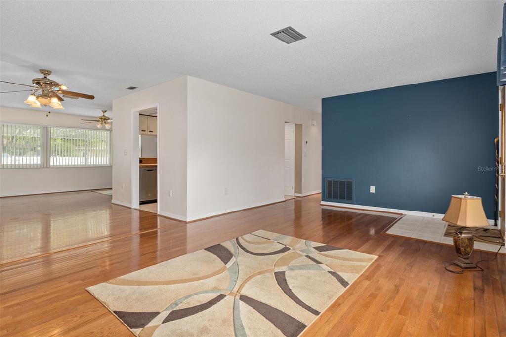 3217 Abeline Road Spring Hill, FL 34608 - Photo 11 of 48 a living room with furniture and wooden floor