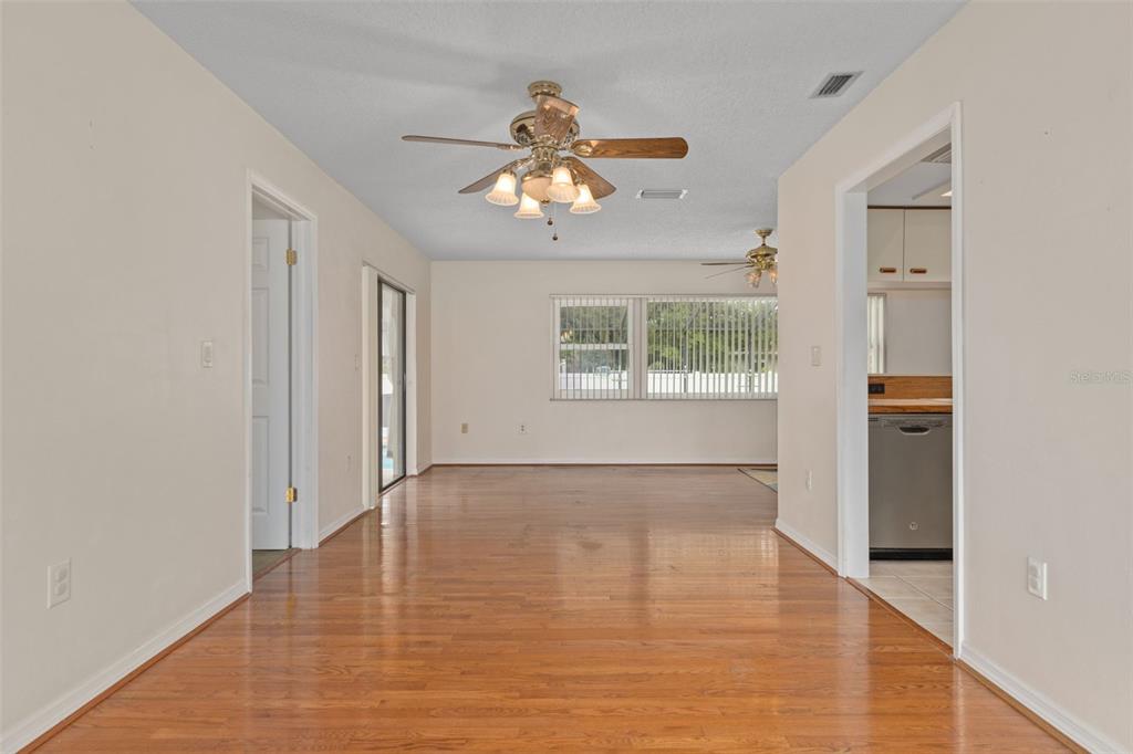 3217 Abeline Road Spring Hill, FL 34608 - Photo 12 of 48 wooden floor in an empty room with a window