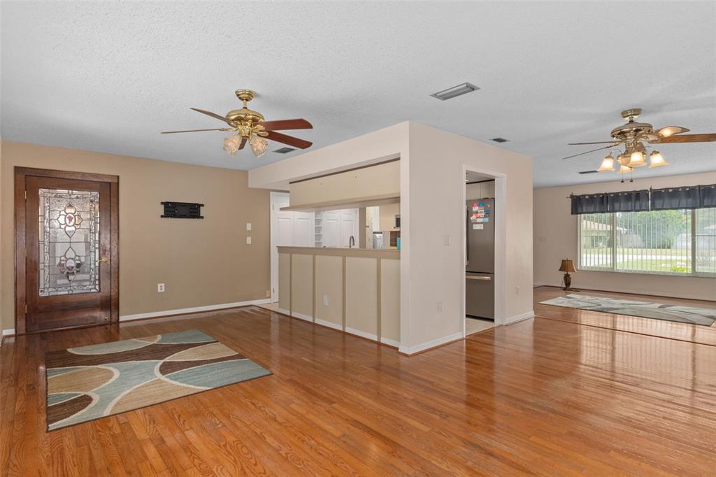 3217 Abeline Road Spring Hill, FL 34608 - Photo 15 of 48 a view of an empty room with window and wooden floor