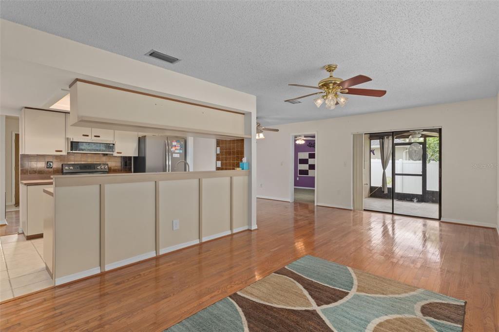 3217 Abeline Road Spring Hill, FL 34608 - Photo 16 of 48 a view of a kitchen with furniture and wooden floor