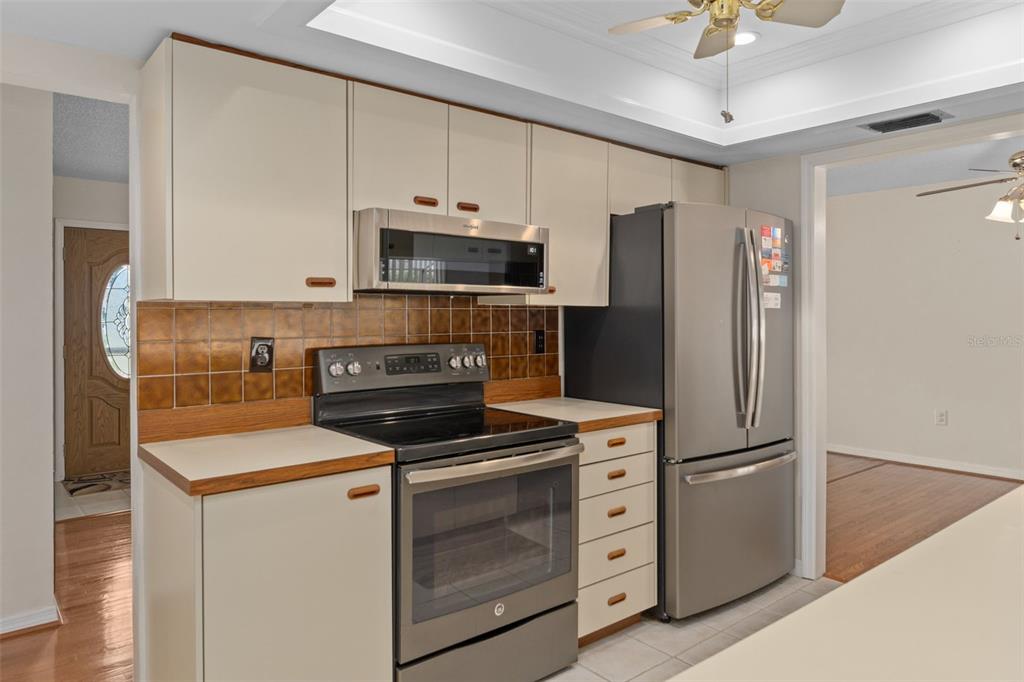 3217 Abeline Road Spring Hill, FL 34608 - Photo 19 of 48 a kitchen with cabinets stainless steel appliances and a counter space