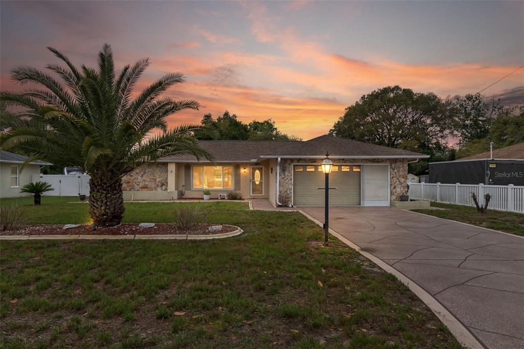 3217 Abeline Road Spring Hill, FL 34608 - Photo 2 of 48 a front view of house with yard and green space