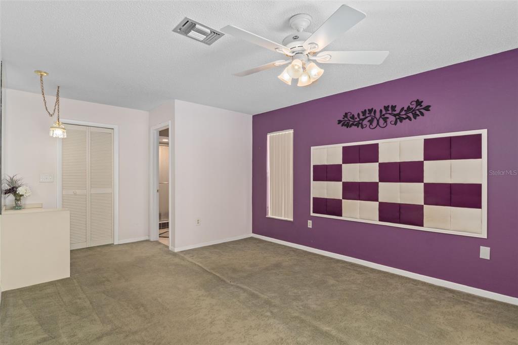 3217 Abeline Road Spring Hill, FL 34608 - Photo 22 of 48 a view of a livingroom with a chandelier fan and kitchen view