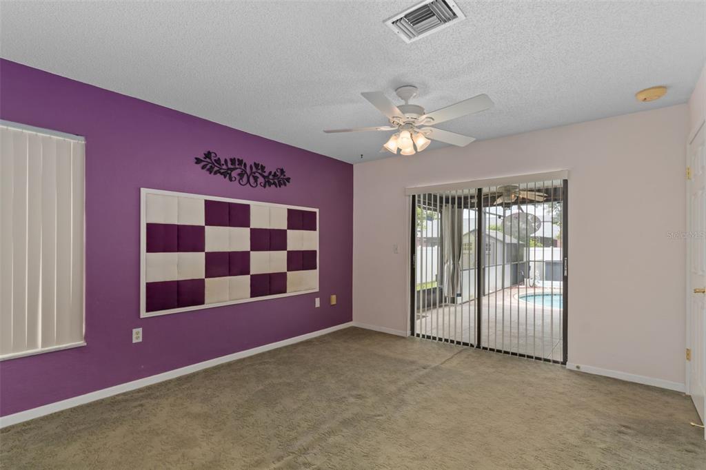3217 Abeline Road Spring Hill, FL 34608 - Photo 23 of 48 a view of a livingroom with an empty space and a ceiling fan