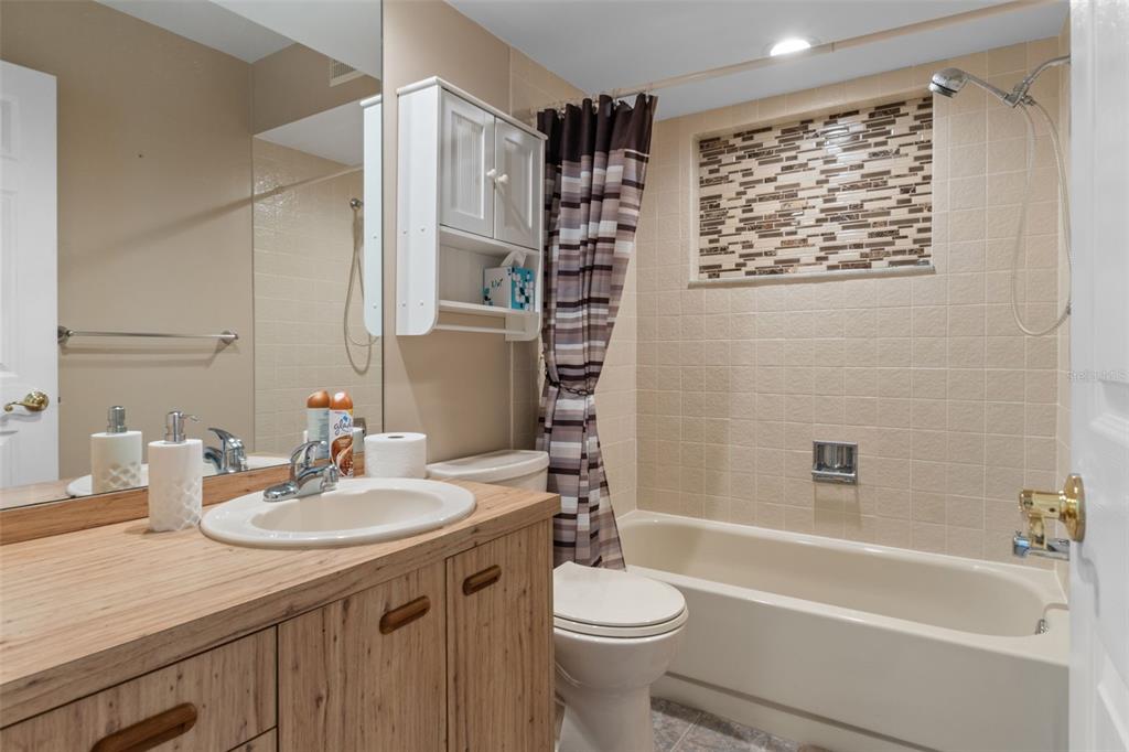 3217 Abeline Road Spring Hill, FL 34608 - Photo 30 of 48 a bathroom with a sink a toilet and shower
