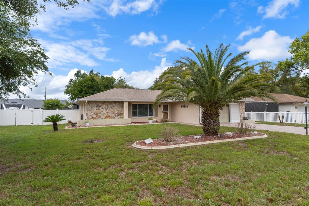 3217 Abeline Road Spring Hill, FL 34608 - Photo 3 of 48 a front view of a house with garden
