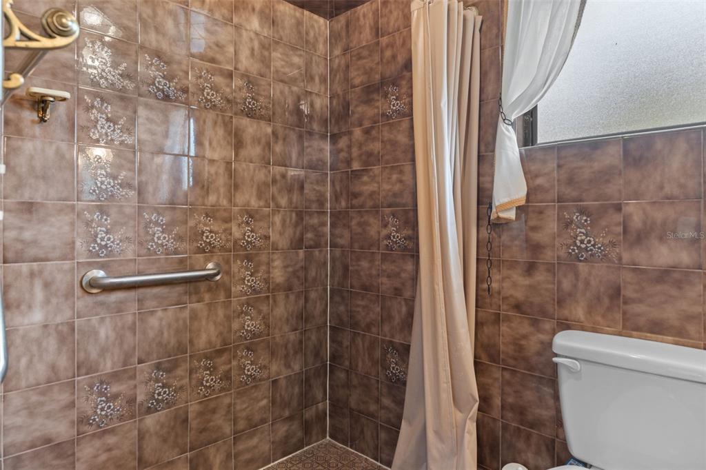 3217 Abeline Road Spring Hill, FL 34608 - Photo 39 of 48 a bathroom with a shower and a toilet