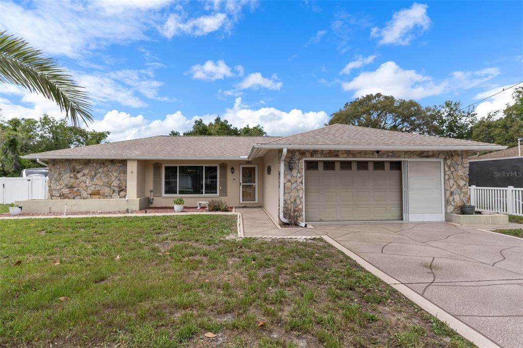 3217 Abeline Road Spring Hill, FL 34608 - Photo 5 of 48 a front view of a house with garden