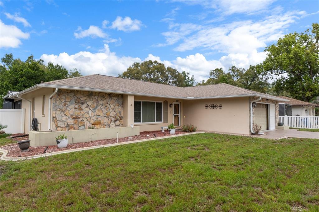 3217 Abeline Road Spring Hill, FL 34608 - Photo 6 of 48 a front view of a house with garden