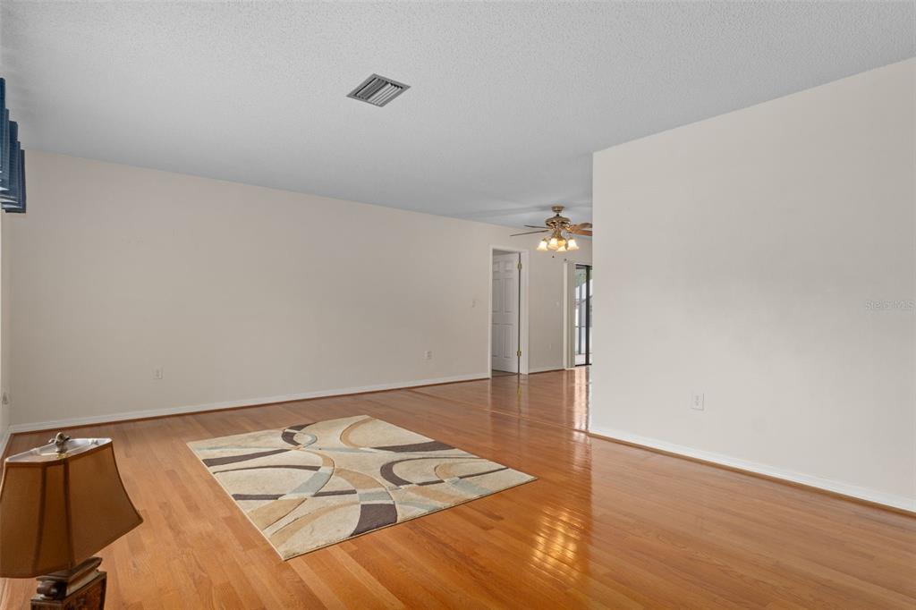 3217 Abeline Road Spring Hill, FL 34608 - Photo 9 of 48 an empty room with wooden floor