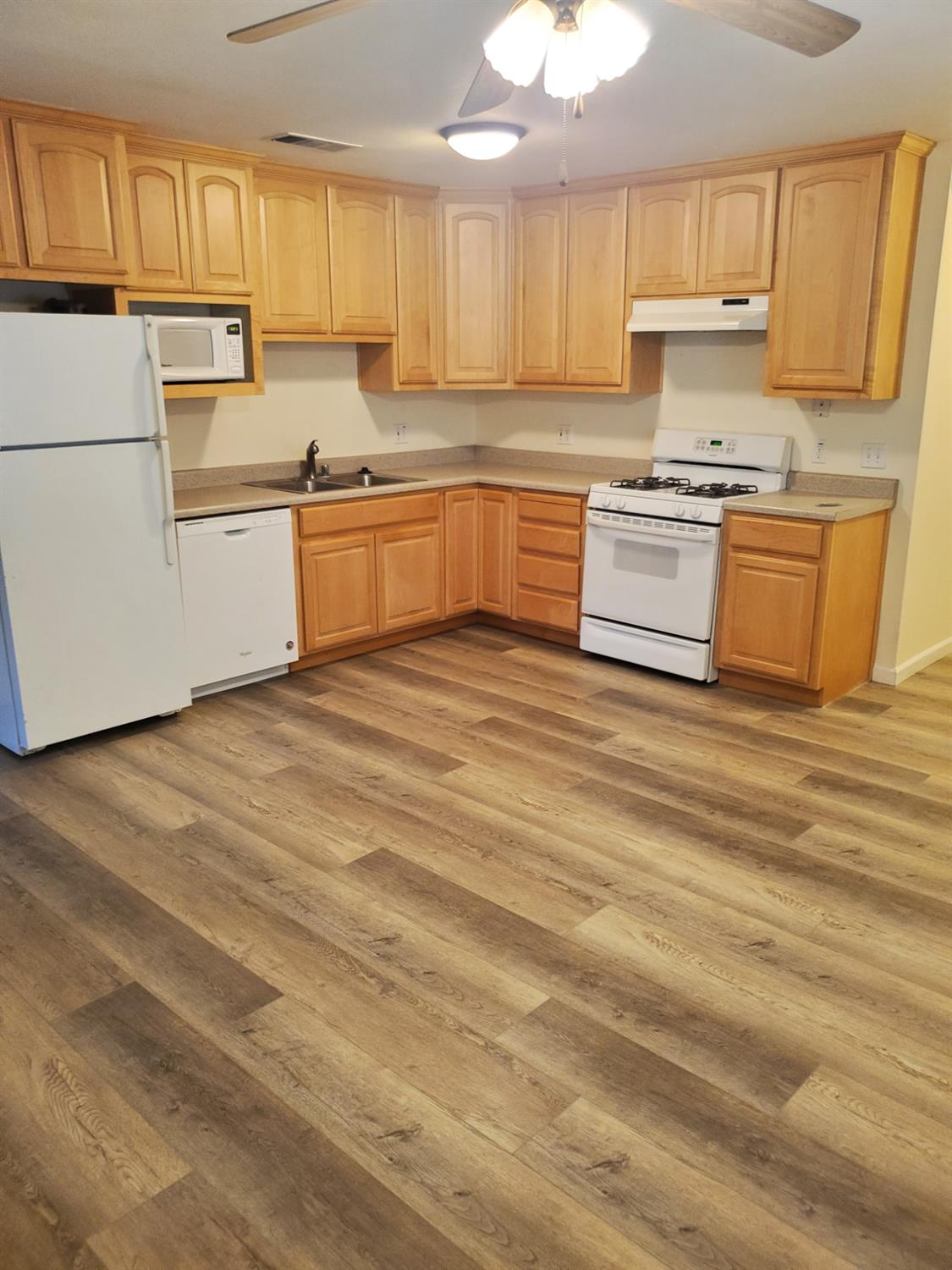 5817 Keyntel Street Citrus Heights, CA 95621 - Photo 22 of 30 a kitchen with stainless steel appliances granite countertop a stove a sink and white cabinets