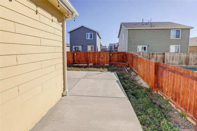 a view of a house with wooden fence