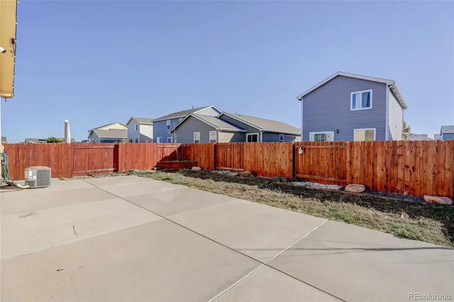 a view of a house with wooden fence
