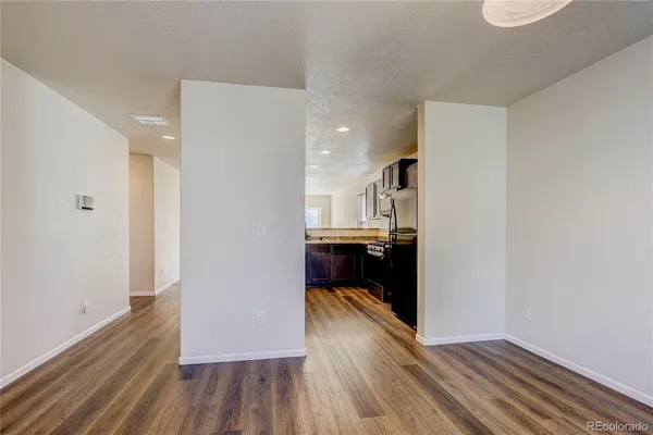 a view of a kitchen from the hallway