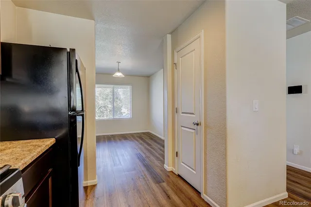 a view of hallway with wooden floor