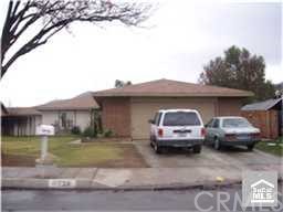 11728 Independence Street Riverside, CA 92503 - Photo 1 of 1 a front view of a house with cars parked