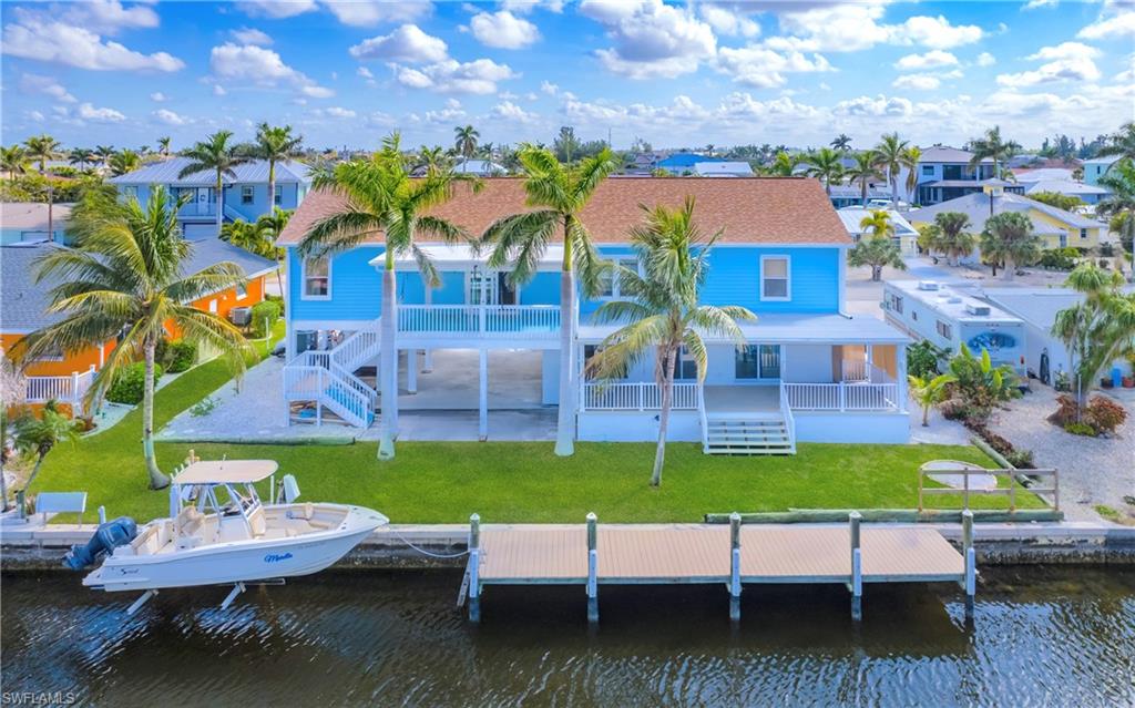12277 Boat Shell Drive Matlacha Isles, FL 33991 - Photo 2 of 46 a view of a house with pool and chairs