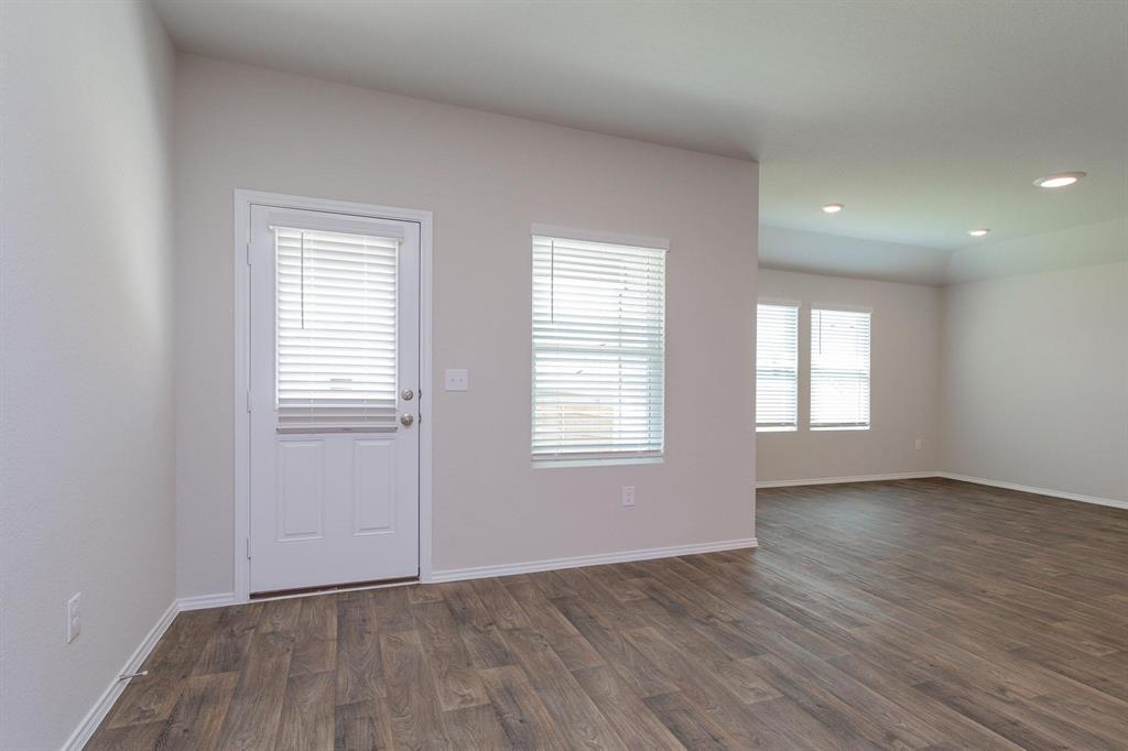 6009 Ronee Leah Drive Austin, TX 78724 - Photo 8 of 16 Durable plank flooring and generous windows create an inviting, low-maintenance living area.