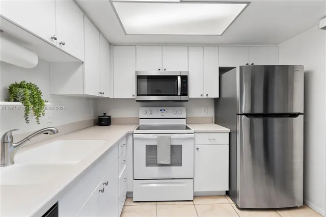 a kitchen with a sink stove and refrigerator