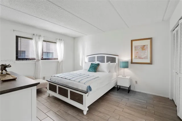 a bedroom with a bed and a desk