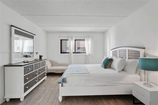 a bedroom with a bed and a mirror