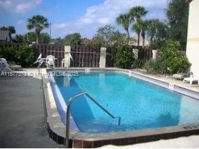 a view of a swimming pool with a table and chairs