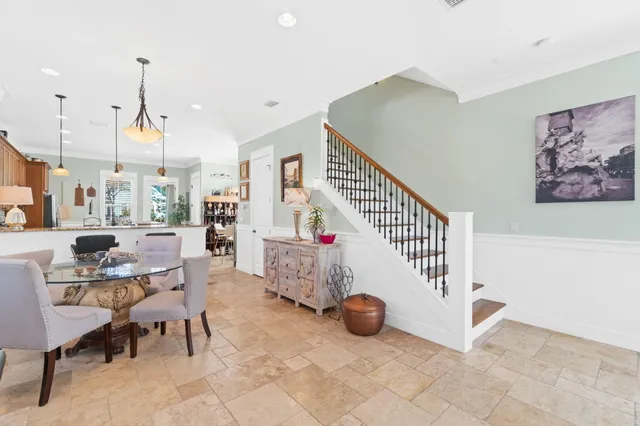 a dining room with furniture and a window