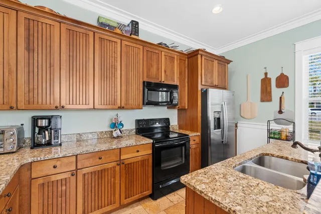 a kitchen with counter top space sink and stove