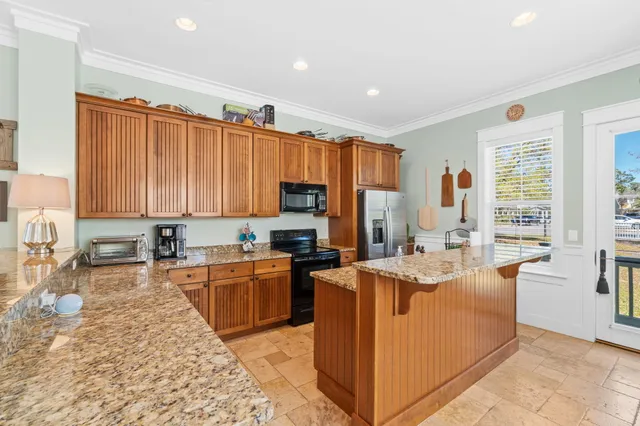 a large kitchen with kitchen island a large counter space dining table and chairs
