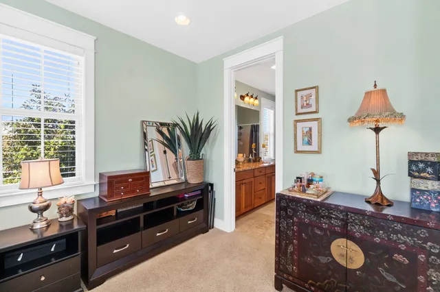 a bathroom with a granite countertop sink a toilet a mirror and shower