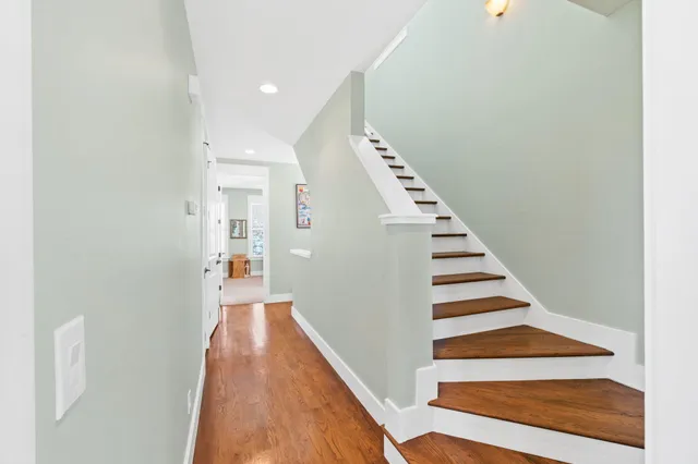 a view of hallway with wooden floor