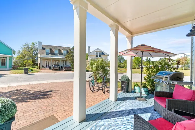 a view of a patio with couches and table and chairs under an umbrella