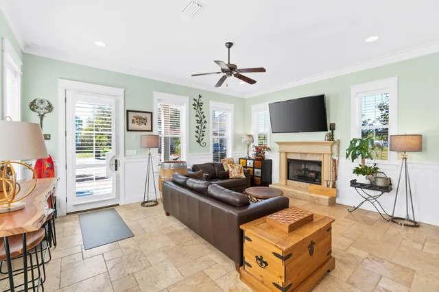 a living room with furniture a fireplace and a flat screen tv