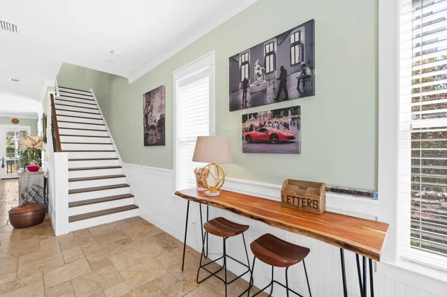 a living room with furniture a flat screen tv and a large window