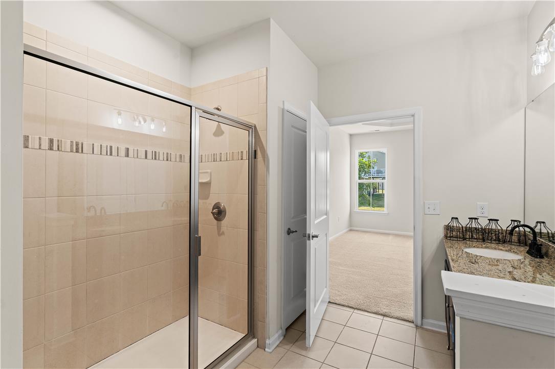 4758 Rafi Road Easton, PA 18045 - Photo 47 of 55 Tiled shower with glass enclosure accompanies a granite-topped vanity, providing a refreshing start to your day.