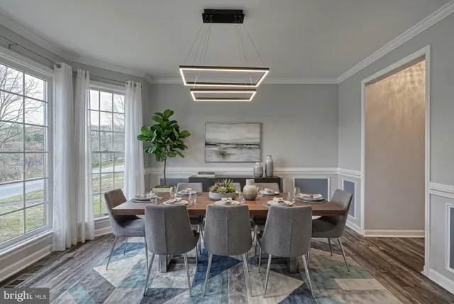 an empty room with windows fireplace and wooden floor