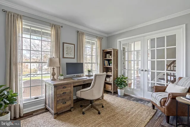 a living room with furniture a chandelier and a large window