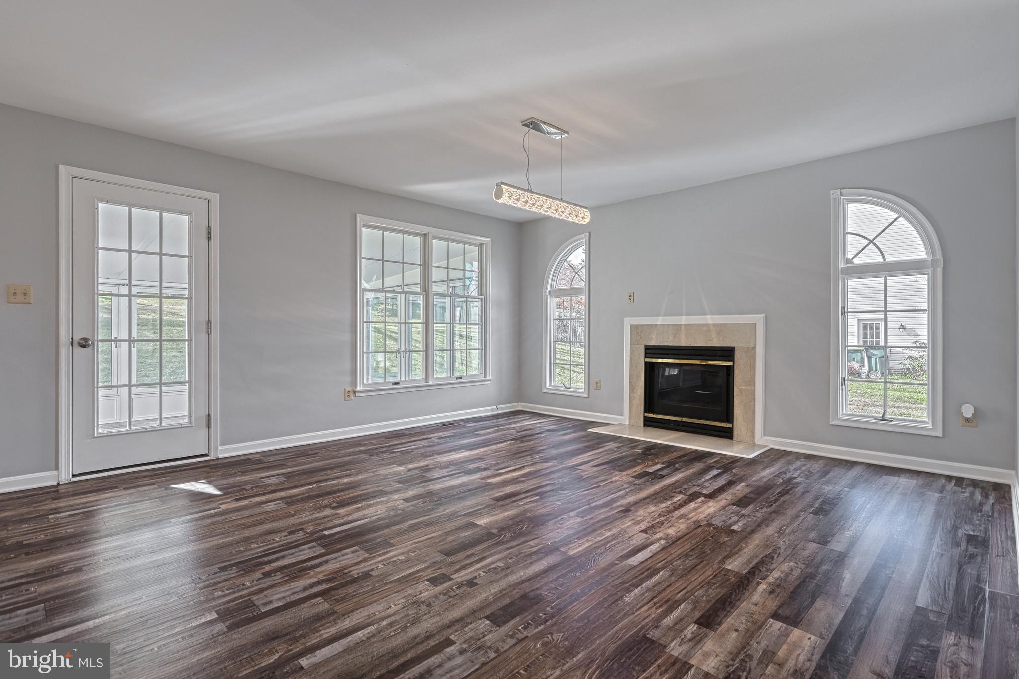 14 Kratz Road Shrewsbury, PA 17361 - Photo 27 of 137 an empty room with windows fireplace and wooden floor