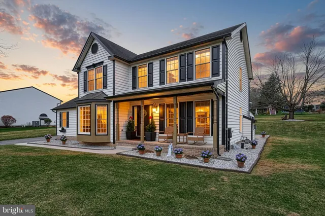 a view of a house with backyard sitting area and garden