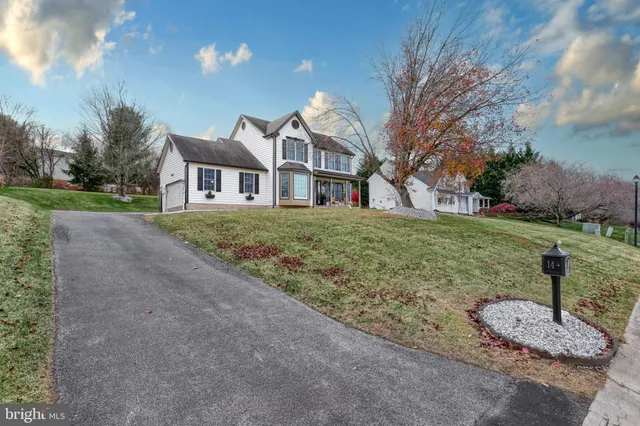 a view of a house with backyard porch and sitting area