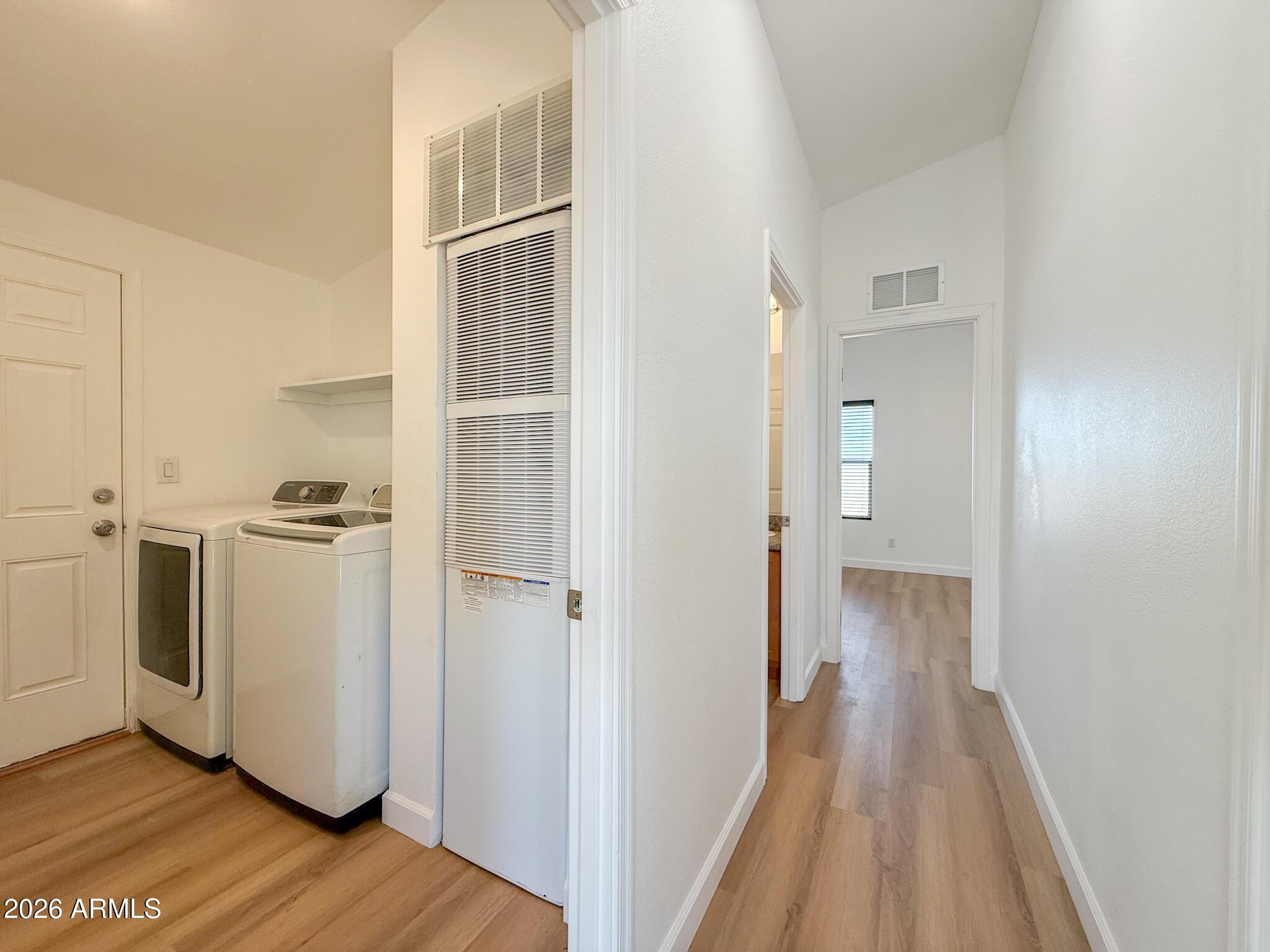 51880 North Gold Plains Road Seligman, AZ 86337 - Photo 13 of 24 a view of walk in closet with wooden floor and cabinet