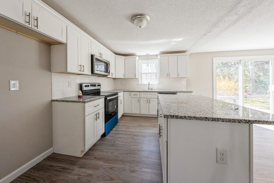 51 Carrie Lee's Way Centerville, MA 02632 - Photo 4 of 15 a kitchen with stainless steel appliances granite countertop a sink and cabinets