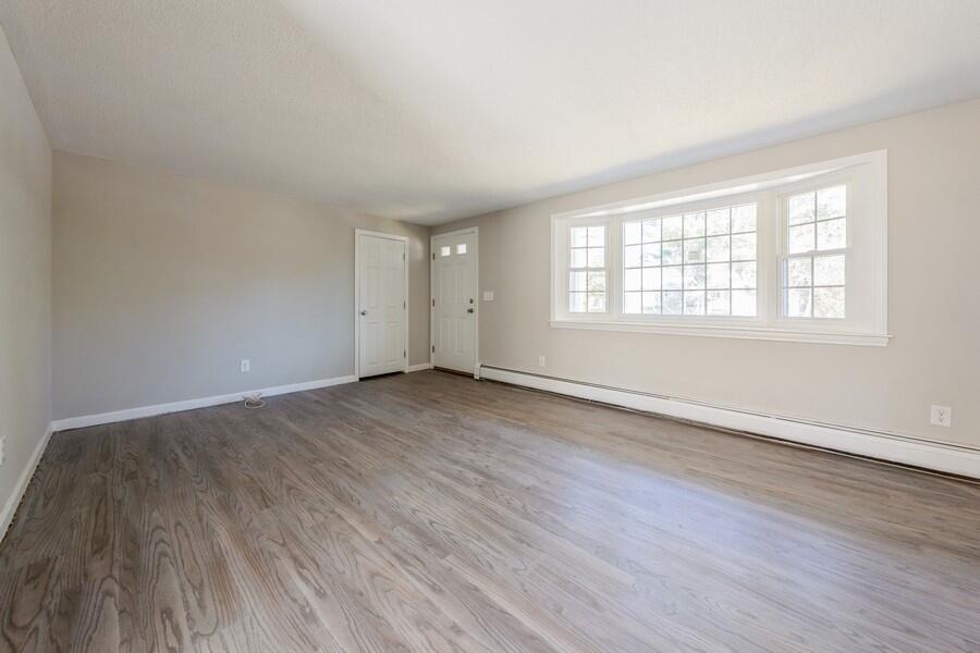 51 Carrie Lee's Way Centerville, MA 02632 - Photo 7 of 15 an empty room with wooden floor and windows