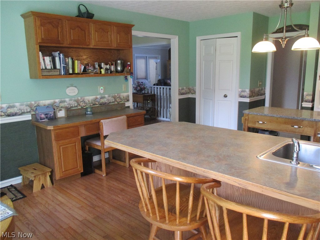 7540 Kennard Road Seville, OH 44273 - Photo 10 of 37 Kitchen with sink, hardwood / wood-style floors, and pendant lighting