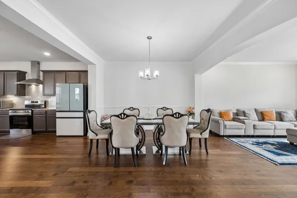 a kitchen with stainless steel appliances kitchen island granite countertop a sink stove and refrigerator