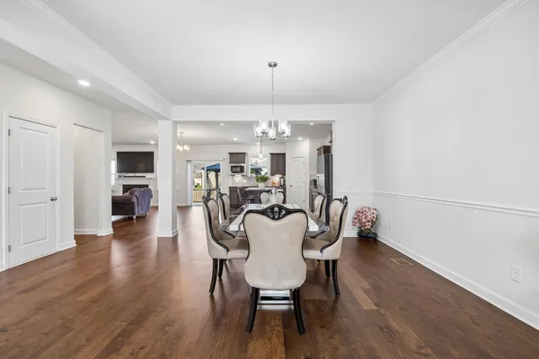 a large kitchen with a table and chairs